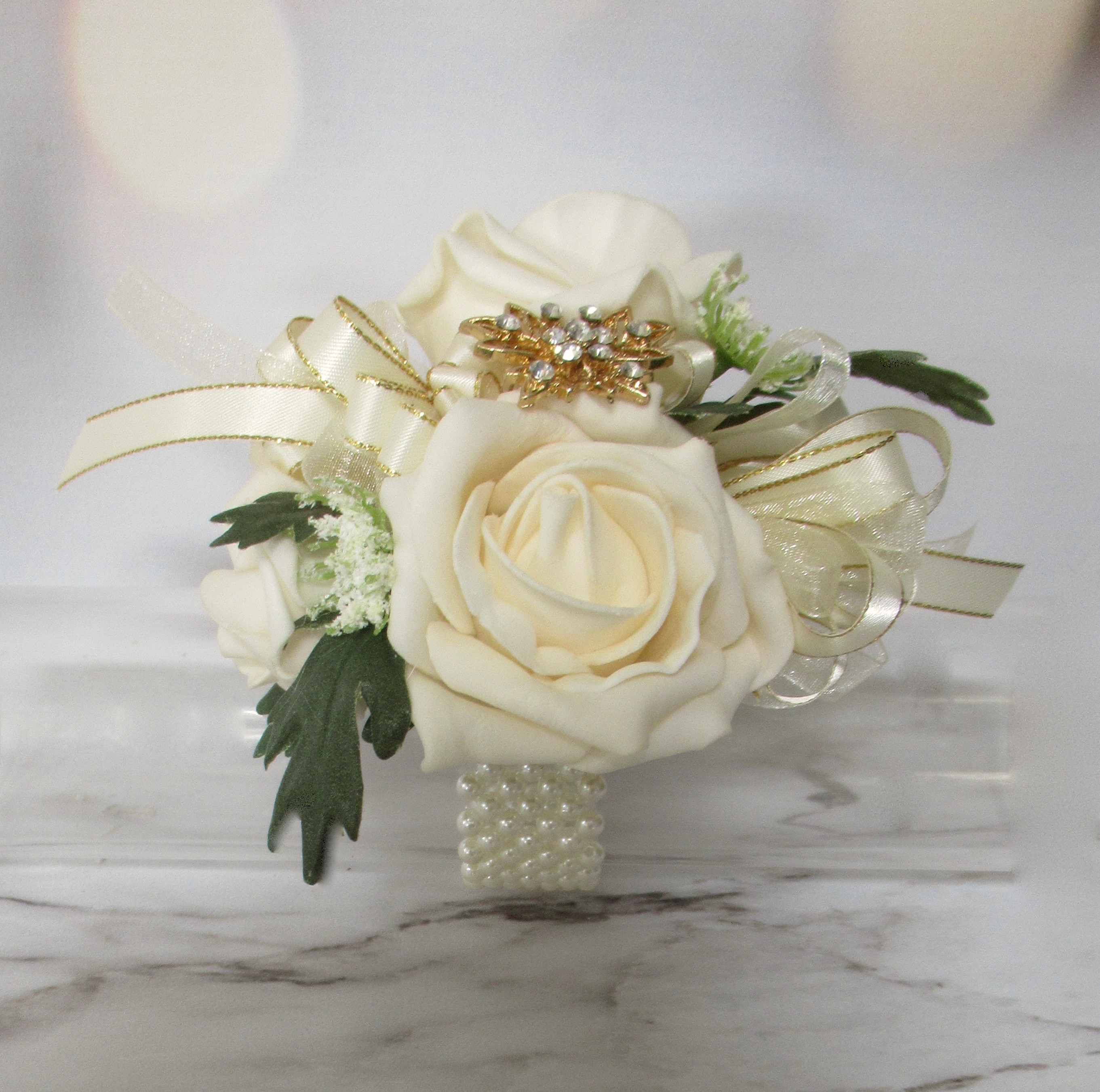 Cream and gold wrist corsage